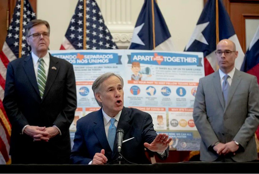 Gov. Greg Abbott, flanked by Lt. Gov. Dan Patrick, left, and House Speaker Dennis Bonnen, speaks during a press conference at the state Capitol over the state's response to the coronavirus on March 31, 2020.